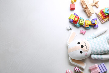 Different toys on light background, flat lay. Space for text