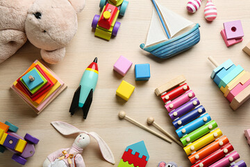 Different toys on wooden background, flat lay