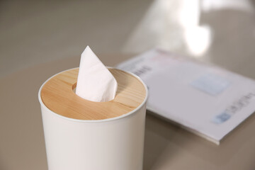 Box with paper tissues on light table, closeup