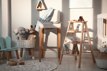 Beautiful baby room interior with stylish wooden ladder