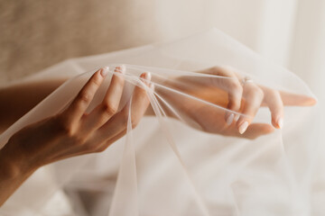 hands of the bride under the veil. Tenderness. 