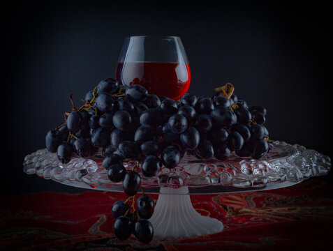 Glass With Cognac And Grapes