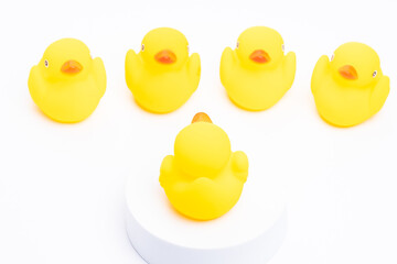A group of yellow rubber duck following the leader