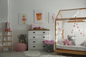 Cute pictures and and stylish furniture in baby room interior