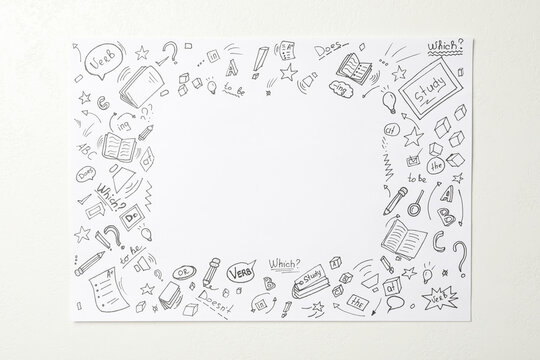 Paper with frame of drawings and space for text on light background, top view. Learning English