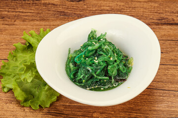 Green Chuka Seaweed Salad Isolated on White Background Top View. Wakame Sea Kelp Salat