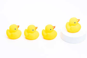 A group of yellow rubber duck following the leader