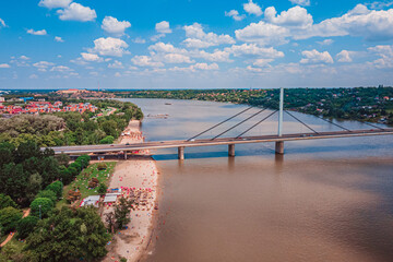 Town beach called Strand and bridge of Novi Sad on river Danube with beautiful clouds