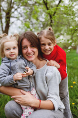 Spring portrait of  mother with two little girls