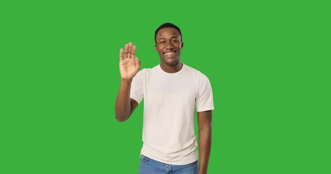 Happy african american man waving hand and greeting hello 