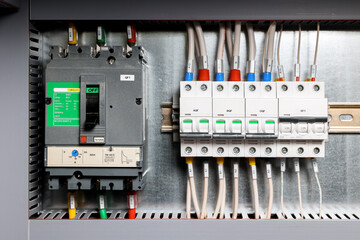 Electrical control Cabinet with an open door. Modern electrical control Cabinet with the door open, close-up. Voltage stabilizer, fuse, switch, terminals. Electrical equipment background