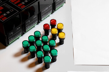 Automatic modules and relays, off and on buttons for the assembly of electrical cabinets. Copy space to insert text. green, red and yellow plastic buttons