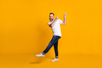 Fototapeta na wymiar Full length body size view of attractive cheerful funky guy dancing having fun fooling isolated over bright yellow color background