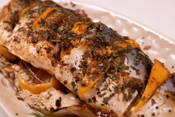 fish stuffed with lemon on a platter diagonal view