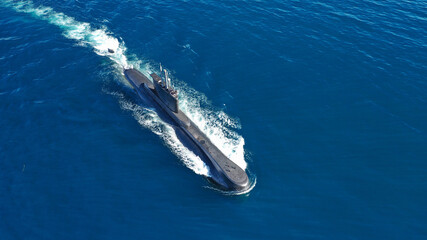 Aerial drone photo of latest technology naval armed forces submarine cruising in deep blue open ocean sea © aerial-drone