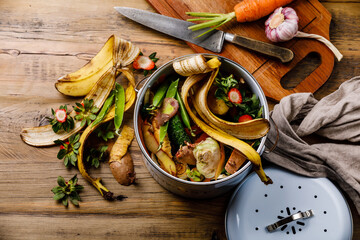 Compost Bucket and Bio waste trash Cooking process on wooden background