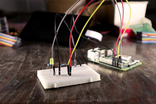 electronic workshop. collage of components related to robotics and electronics. circuit of LEDs, resistors, colored cables, connections. 