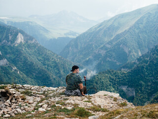Fototapeta na wymiar Man relax in the mountains on nature beautiful landscape fresh air fog sunlight