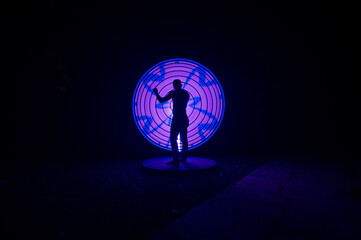 one person standing against beautiful purple and blue circle light painting as the backdrop