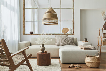 Stylish interior of living room with design modular sofa, furniture, wooden coffee table, rattan...