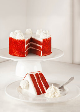 Red velvet cake isolated on white with slice whipped cream ready to serve