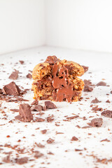 Chocolate chip cookie with crushed chocolate ingredients and oozing melted chocolate