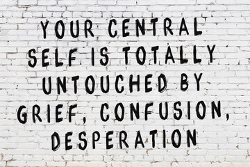 Black painted inscription of smart quote on white brick wall