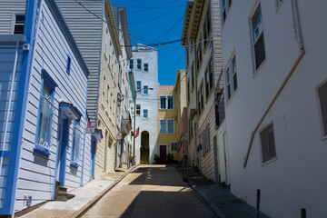 View of narrow street with colorful wood buildings at the North Beach neighborhood, in the city of San Francisco.