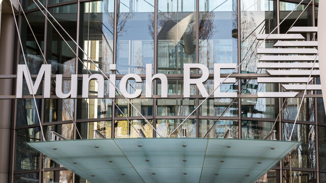Munich, Bavaria / Germany - Mar 18, 2020: Close up of Munich Re logo / sign above the entrance of the Leopoldstraße offices. Munich Re is one of the largest Reinsurance companies in the world.