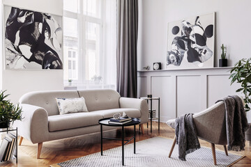 Stylish scandinavian home interior of living room with design gray sofa, armchair, marble stool,...