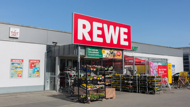 Starnberg, Bavaria / Germany - Mar 27, 2020: View on the entrance of a Rewe supermarket. With large Rewe sign / logo above entrance.