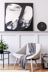Stylish scandinavian home interior of living room with design gray armchair, modern stool, black...