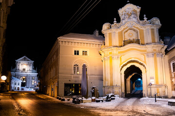 Fototapeta na wymiar Holy Trinity Church, Basilian monastery gate and Church of St. Theresa, Roman Catholic church in Vilnius Old Town, night view