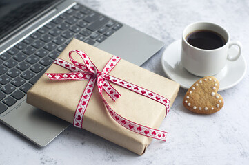 laptop, gift box, cup of coffee, heart-shaped cookies. gift with love.