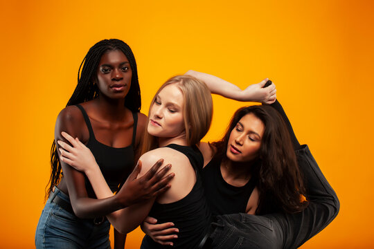 diverse multi nation girls group, teenage friends company cheerful having fun, happy smiling, cute posing on yellow background, lifestyle people concept, african-american, asian and caucasian