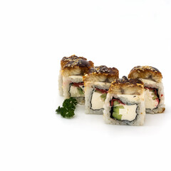 A set of dragon rolls with eel. Sprinkled with sesame seeds on top. Nearby is a sprig of curly parsley. Isolated over white background.
