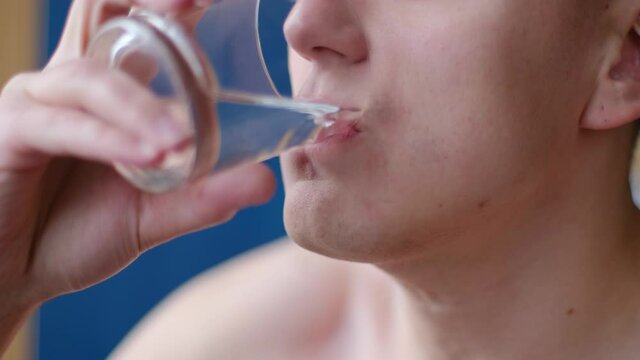 Young man drinking water from a glass