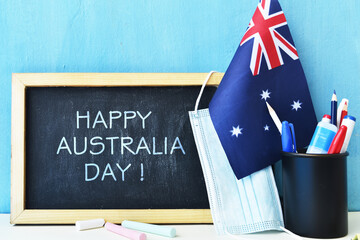 Happy Australia day concept with flag, blackboard, school stationery, medical mask