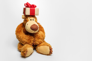 Teddy bear with a gift on his head