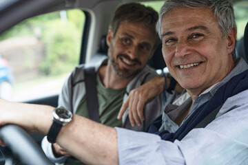Father and son sitting in car