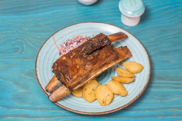 Delicious and hearty texas ribs with homemade potatoes and salad
