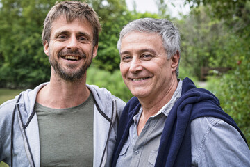 Father and son standing in garden