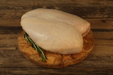 Raw whole chicken breast with skin
