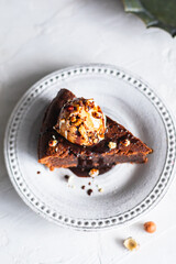 Chocolate cake with ice cream, nuts and chocolate sauce