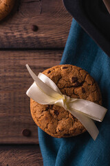 Chocolate cookies on a wooden table decorated with a blue napkin
