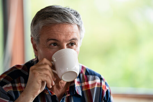 Close-up of senior man drinking coffee
