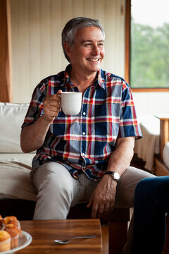 Smiling senior man having coffee