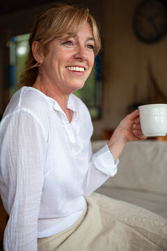 Smiling senior woman having coffee