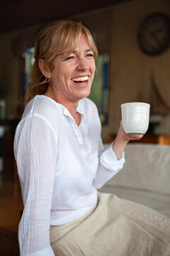Smiling senior woman having coffee