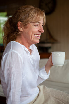 Smiling senior woman having coffee